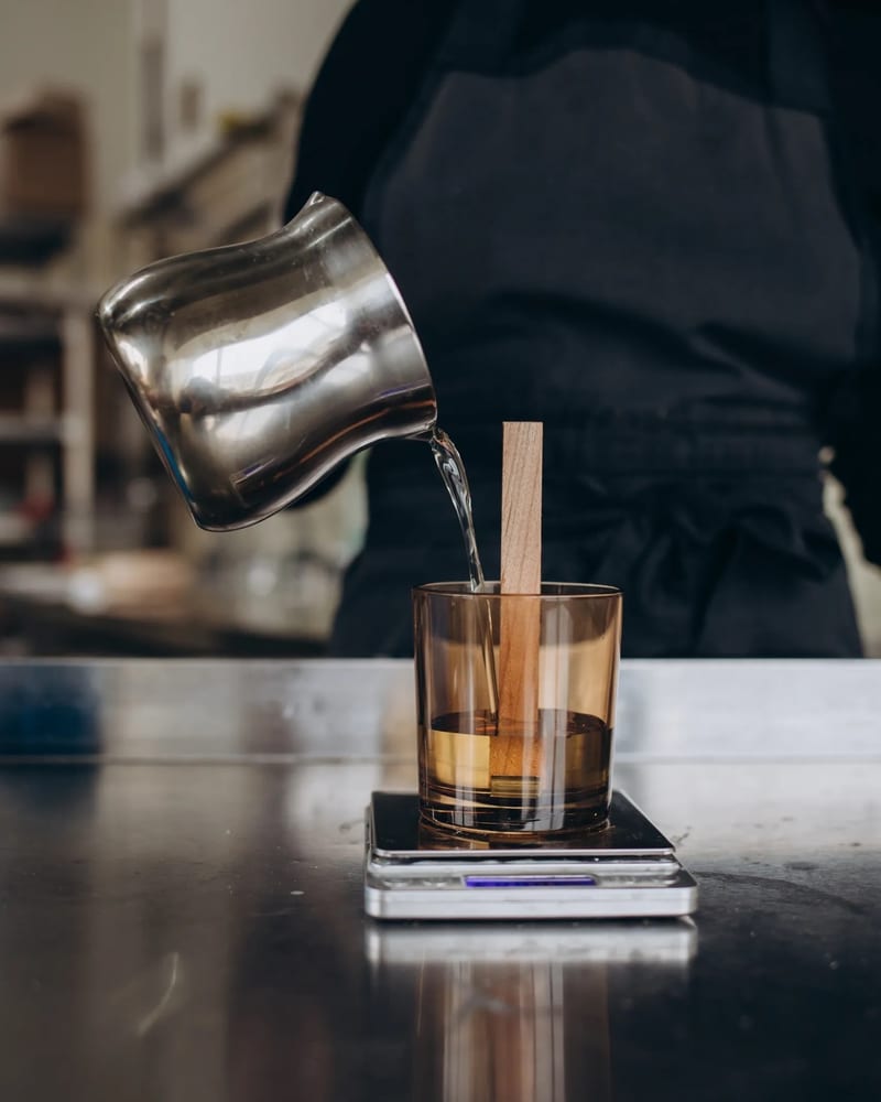 Artisan pouring handcrafted candles with care