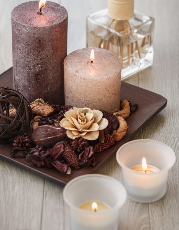 Single candle flame burning with warm intentional glow